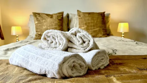 Room 4, towels folded on the bed