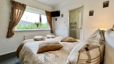 Room 1, the bed by the window
