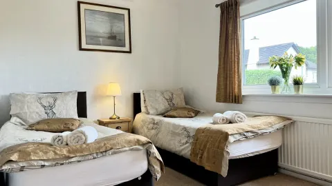 Room 3, the beds and chair by the window